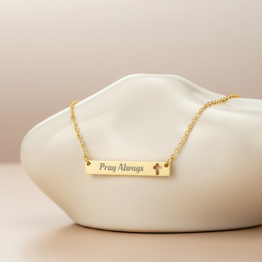 Gold Pray Always engraved bar necklace with cross cutout on white stone, minimalist faith jewelry