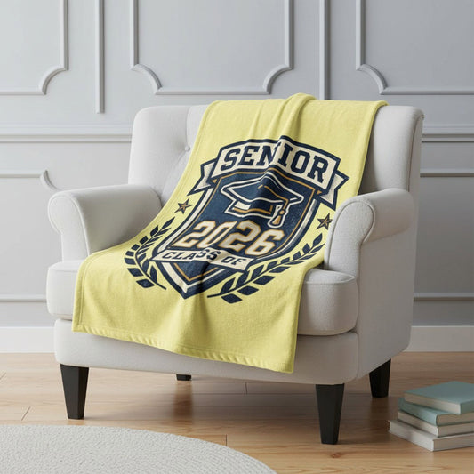 Class of 2026 Senior graduation blanket in yellow draped over white chair, cozy home decor gift for grad