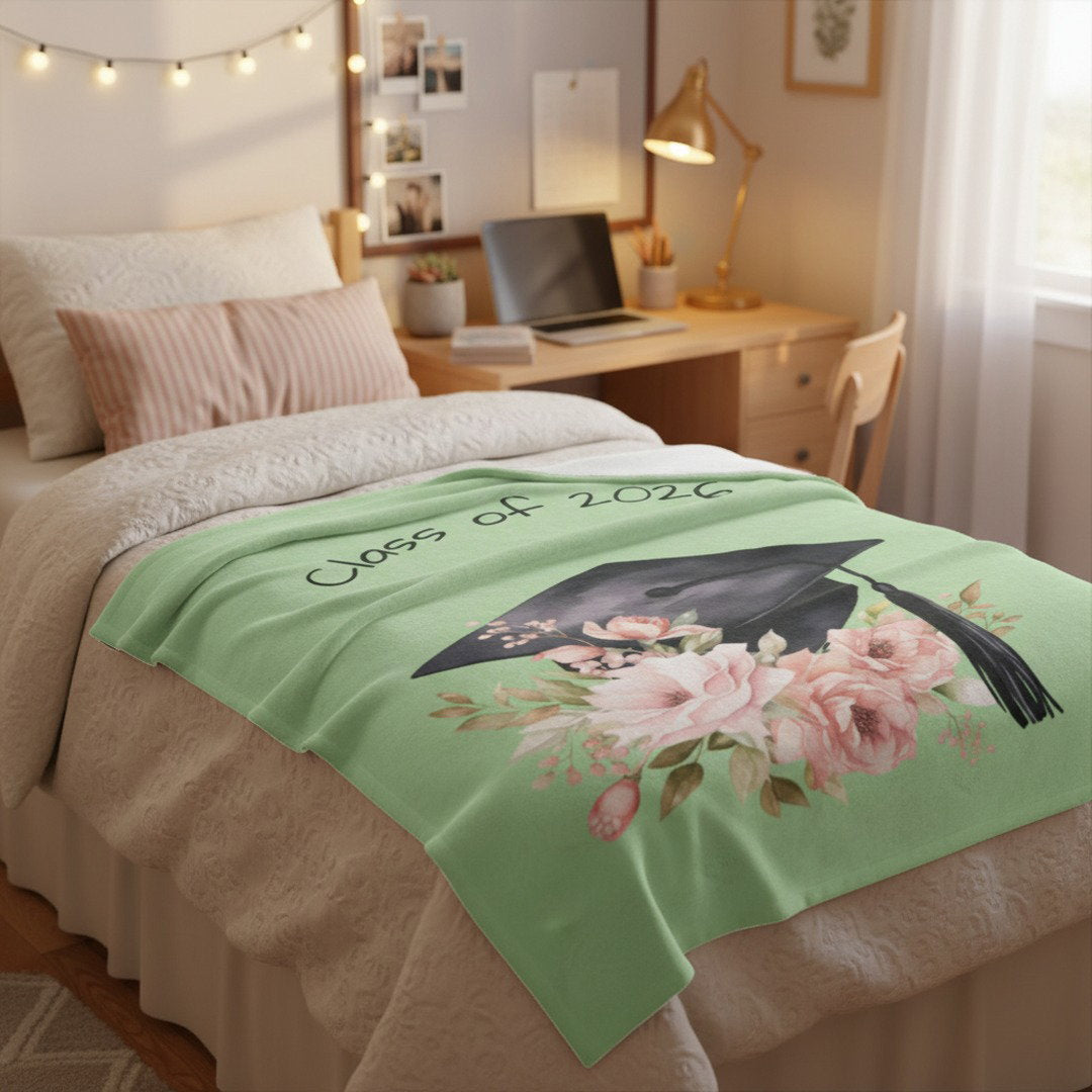 Sage green Class of 2026 graduation blanket on college dorm bed, thoughtful going away gift for high school senior
