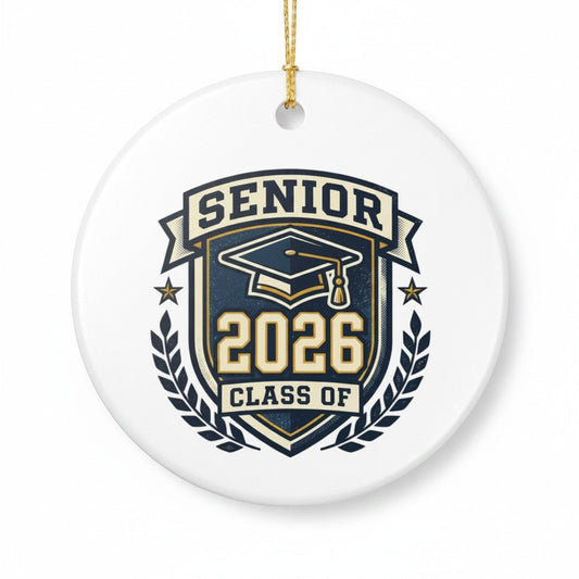 Senior 2026 Class Of ceramic graduation ornament on white background, navy and gold crest design with gold hanging string, graduation keepsake gift