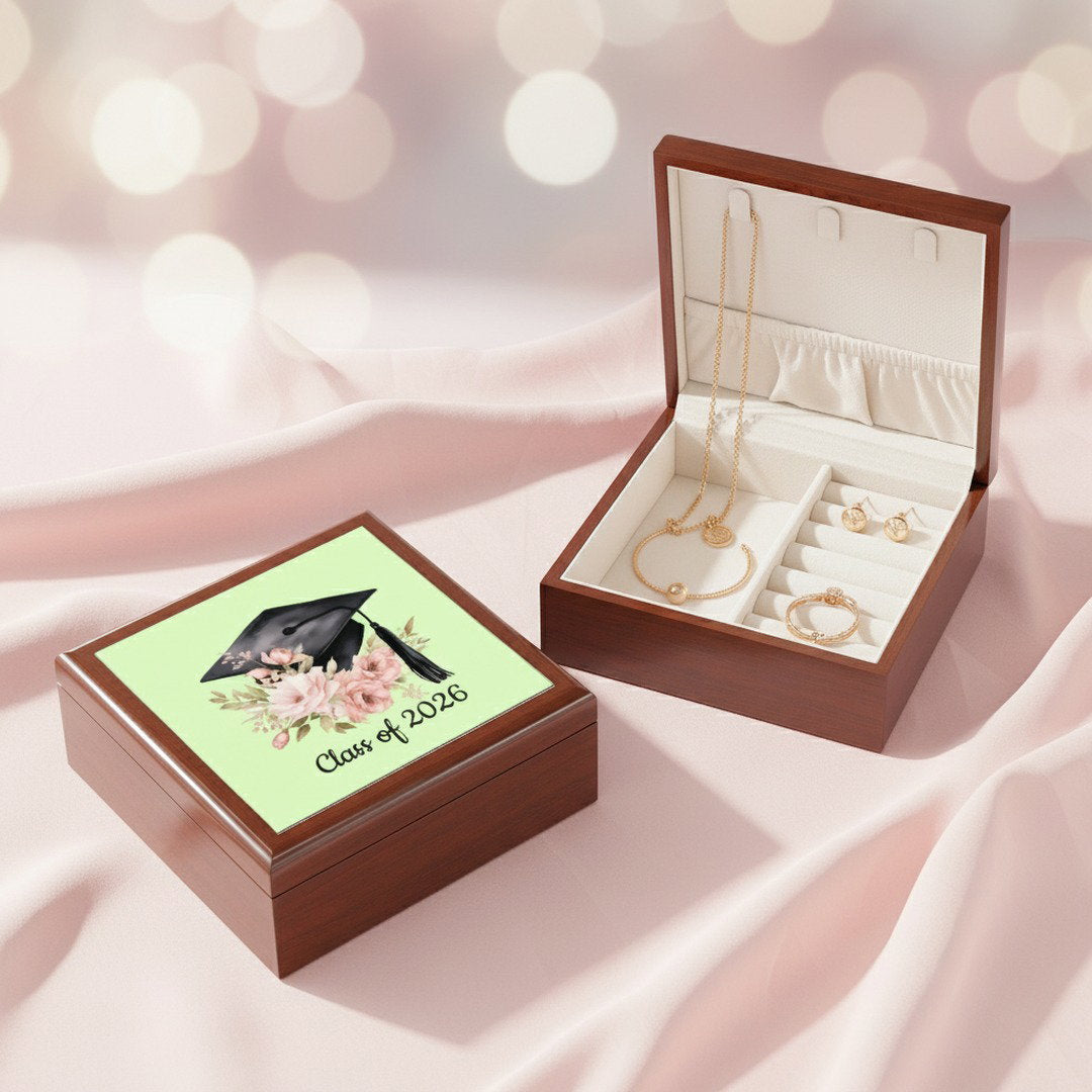 Class of 2026 graduation jewelry box open with gold necklace, bracelet, and earrings on pink satin background