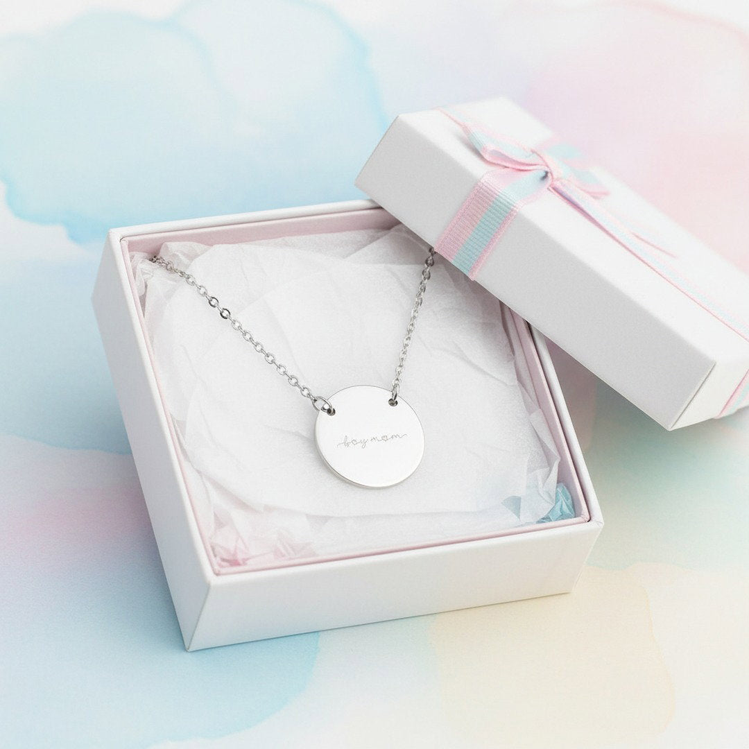 Silver engraved "Boy Mom" disc necklace displayed in open white gift box with pastel tissue paper and ribbon, ready to gift Mother's Day jewelry