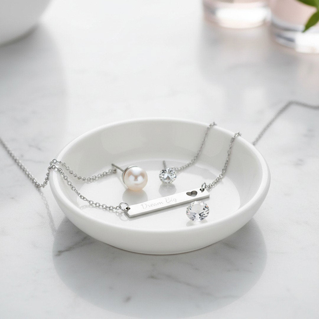 Silver Dream Big bar necklace in white ceramic dish with pearl and crystal earrings on marble surface
