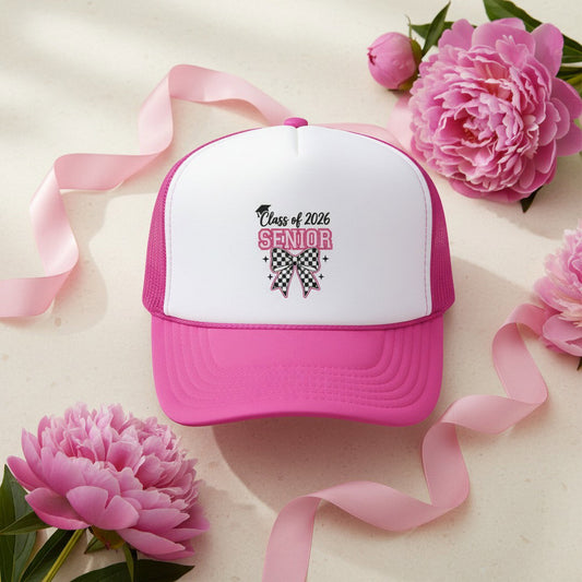  Pink and white Class of 2026 Senior Bow trucker cap flat lay on cream background surrounded by pink peonies and pink satin ribbon, feminine graduation gift idea