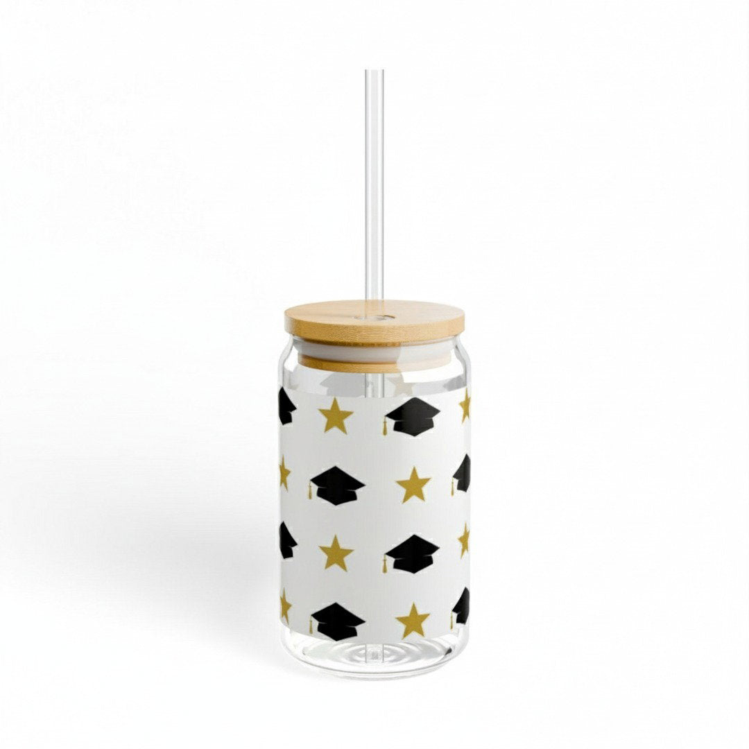 Graduation sipper glass with black grad caps and gold stars pattern, bamboo lid and clear glass straw, clean white background product shot, Class of 2026 graduation gift