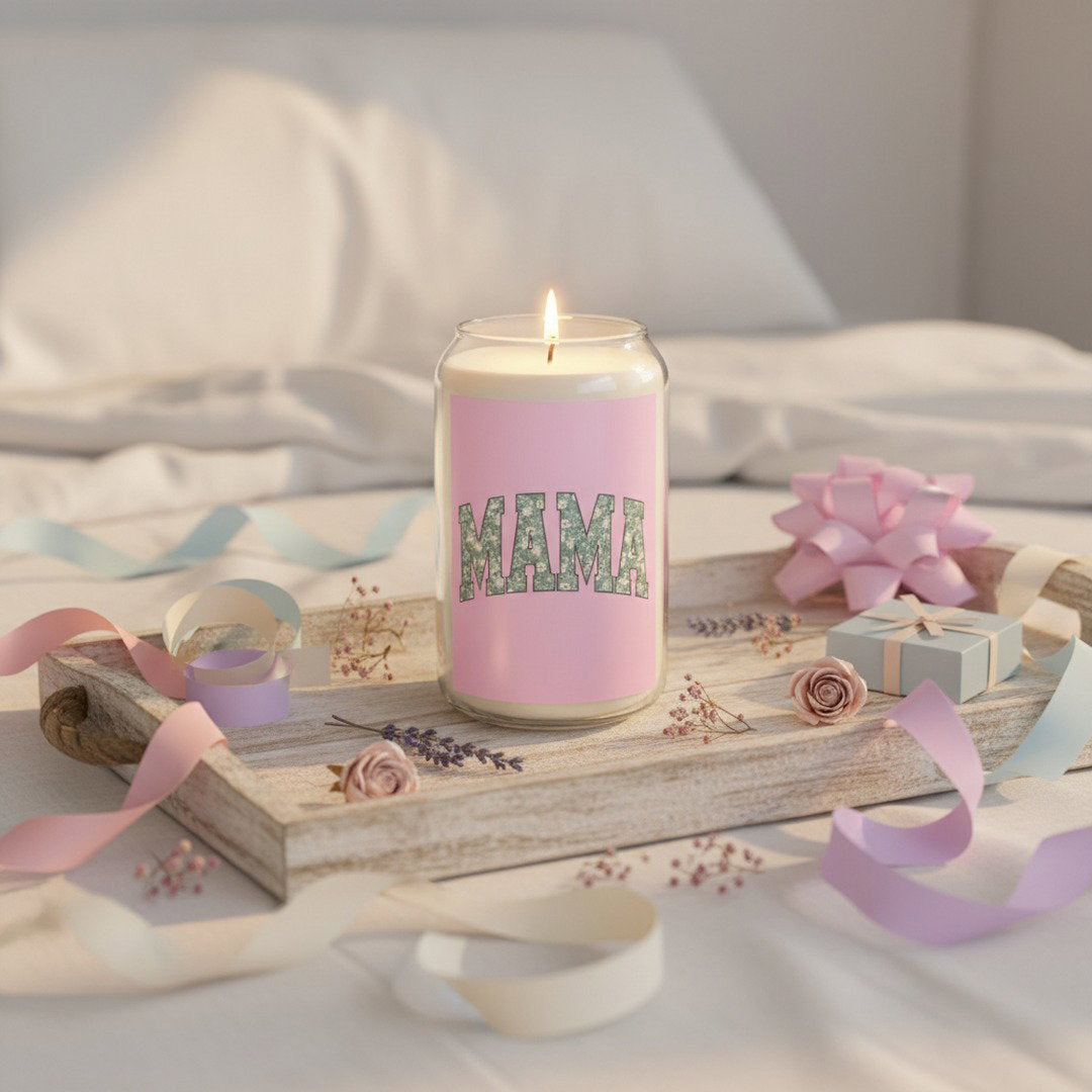 MAMA soy candle in glass jar on rustic wooden tray on white bed, surrounded by pastel pink and lavender ribbons, dried flowers, and small gift box, Mother's Day gift idea